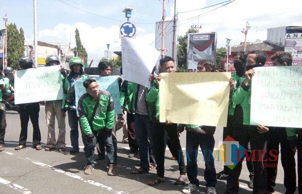 Para Ojol saat menggelar aksi yang digelar di bundaran DPRD usai sholat Jumat (foto : Moh. Ali Makrus / JatimTIMES)