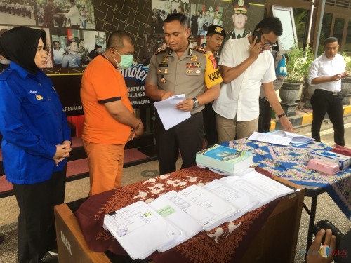 Kepala Desa Balearjo Riduan, tersangka kasus tindak pidana korupsi saat sesi rilis di halaman Polres Malang, Kabupaten Malang (Foto : Ashaq Lupito / MalangTIMES)