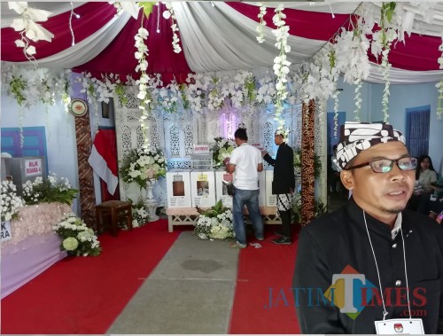 Suasana TPS 16 Desa Kromengan dengan konsep pesta pengantin. Ketua KPPS 16 Purwadi saat menyampaikan konsep di sela pencoblosan (Nana)