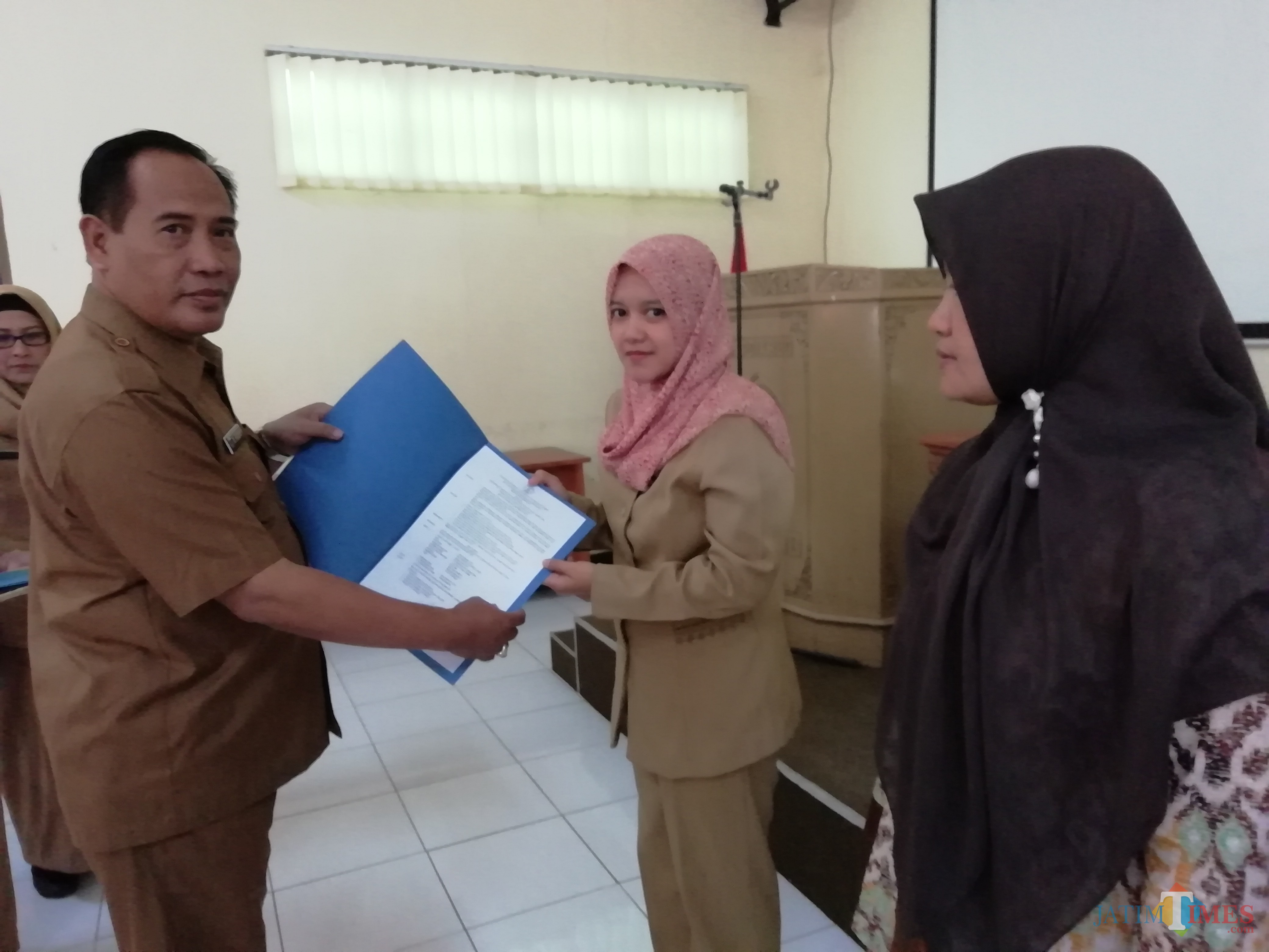 Kepala Dinas Pendidikan Kabupaten Malang M. Hidayat saat menyerahkan secara simbolis SK penyetaraan guru non-PNS, Selasa (25/06/2019). (Nana)