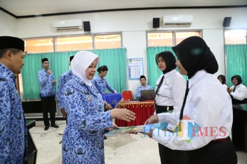 Bupati Kediri Hj Haryanti Sutrisno menyerahkan SK CPNS kepada salah satu bidan. (Eko Arif S /JatimTIMES)