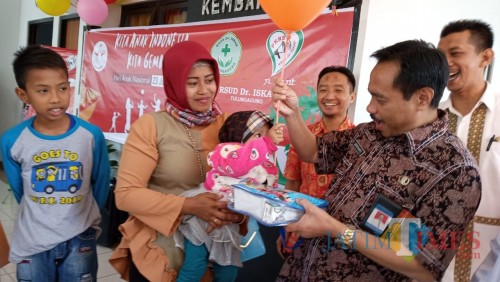 Direktur RSUD dr. Iskak, Supriyanto saat memberikan balon pada salah satu anak. (foto : Joko Pramono/Jatim Times)