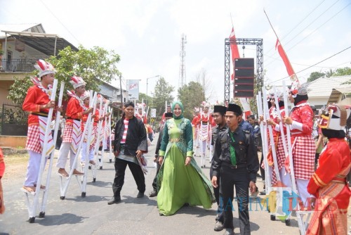 Bupati Jember dr. Hj. Faida MMR saat disambut peserta Festival Egrang di Tanoker Ledokombo (foto : Izza / Jatim TIMES)