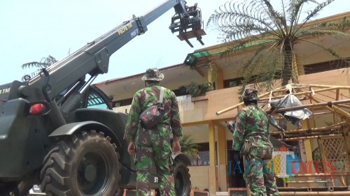 Petugas TNI saat melakukan pembersihan di di SDN Tulungrejo 03 Kota Batu, Selasa (22/10/2019). (Foto: Irsya Richa/MalangTIMES)