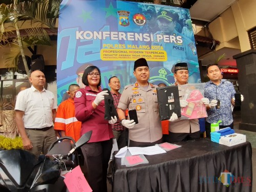 Kapolres Malang Kota AKBP Dony Alexander (berkopyah) saat menunjukkan barang bukti hasil sindikat pembobolan rumah di halaman Mapolresta, Kamis (24/10) (Arifina Cahyanti Firdausi/MalangTIMES)