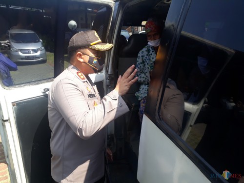 Kapolres Malang AKBP Hendri Umar saat memberikan arahan kepada para penumpang angkutan umum yang tampak melebihi kapasitas 50 persen di Check Point Bakpau Telo Lawang, Minggu (17/5/2020). (Foto: Tubagus Achmad/MalangTimes)