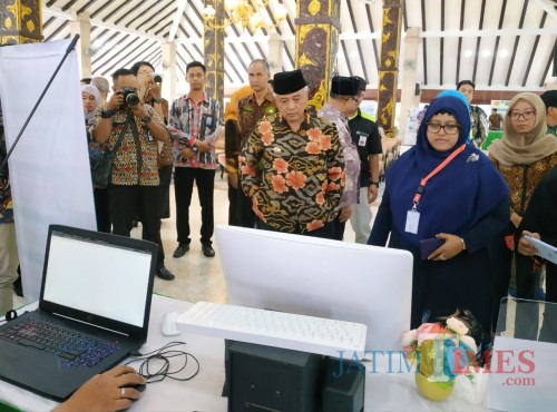 Salah satu tim penilai IGA dari Litbang Kemendagri, Ray Septianis Kartika (kerudung biru), saat melihat inovasi dari Kabupaten Malang. (Hendra Saputra)