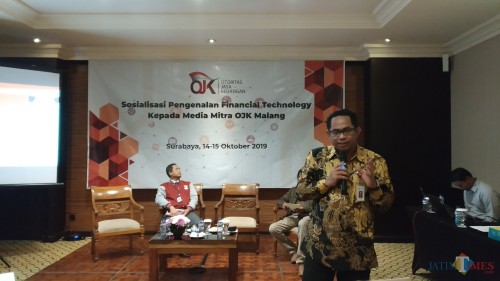 Kepala OJK Malang Sugiarto Kasmuri (berdiri) saat memberi materi dalam kegiatan Sosialisasi Pengenalan Financial Technology kepada Media Mitra OJK. (Pipit Anggraeni/MalangTIMES).