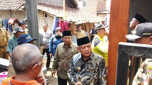 Bupati Malang M Sanusi (tengah kenakan batik dan berkopiah) saat meninjau langsung rumah terdampak angin kencang di Dusun Jatiarjo Kecamatan Jabung (Pipit Anggraeni/MalangTIMES).
