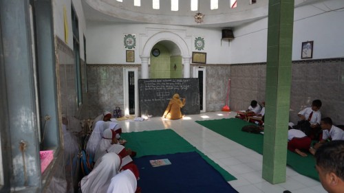 Sejumlah siswa mengikuti kegiatan belajar mengajar di musala.