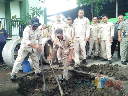 Petugas saat membuat sumur injeksi di kawasan perkantoran Dinas Pekerjaan Umum, Penataan Ruang, Perumahan dan Kawasan Permukiman (DPUPRKP) Kota Malang. (Muslimin/MalangTIMES)