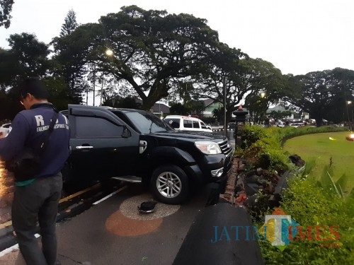 Numpak mobil yang menabrak tembok alun-alun Tugu Kota Malang (Arifina/MalangTIMES)