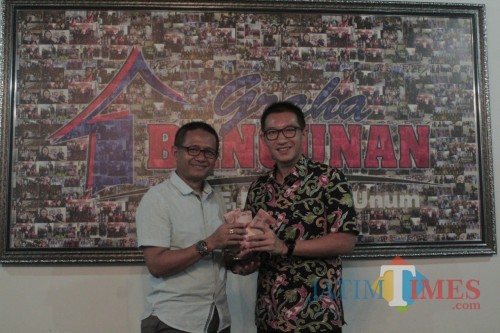 Direktur Utama Graha Bangunan Daniel Lim (kanan) menyerahkan hadiah utama Undian Berhadiah Rp 700 Juta kepada Hidayatur Rofik.(Foto : Aunur Rofiq/BlitarTIMES)
