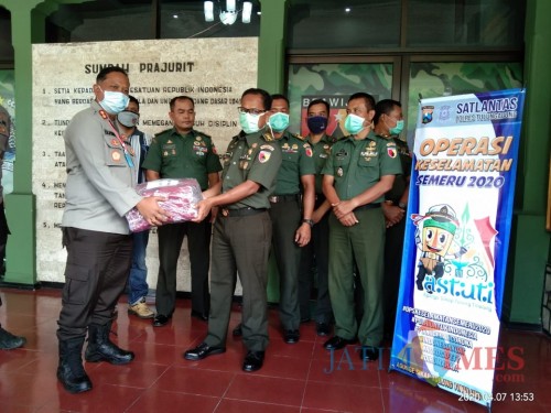 Kapolres Tulungagung, AKBP Eva Guna Pandia saat serahkan bantuan masker pada Dandim Tulungagung. Letkol Inf. Kaharudin (foto: Joko Pramono/JatimTIMES)