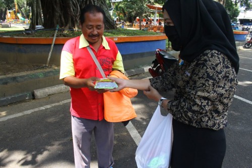 Pewarta Kodew Malang saat membagikan paket bantuan kepada pekerja di jalan yang masih berjuang di tengah pandemi covid-19. (Istimewa).