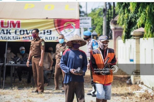 Personel Polres Madiun bersama eks napi dalam kegiatan bagi-bagi nasi. (foto istimewa)