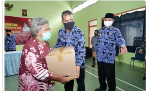Walikota Madiun menyerahkan bantuan paket sembako kepada warga Taman