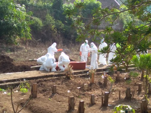 PDP meninggal tengah dikuburkan petugas di TPU Desa Giripurno, Kecamatan Bumiaji. (Foto: istimewa)