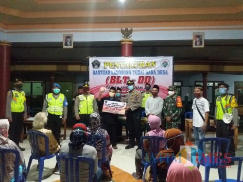 Kapolsek Ponggok AKP Sony mengawal langsung pengamanan penyaluran BLT-DD di 2 desa hingga larut malam.(Foto : Aunur Rofiq/BlitarTIMES)