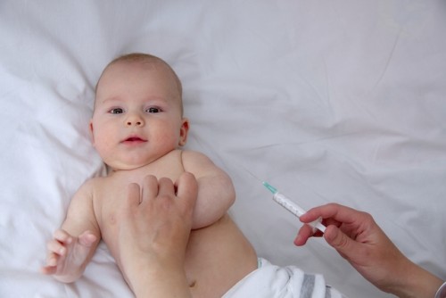 Seorang bayi akan dilakukan suntik imunisasi. (Foto: hello-sehat)
