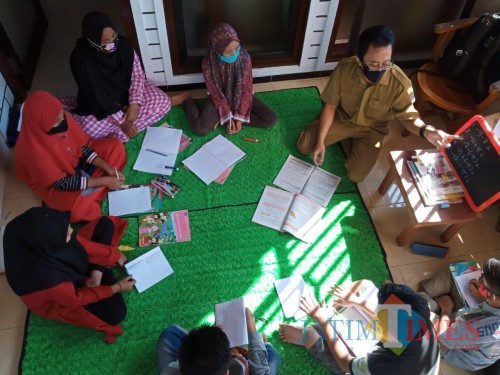 Guru SDN Mangunsari Yenri Sufhianto saat home visiting di rumah salah satu siswanya. (Joko Pramono for Jatim TIMES)