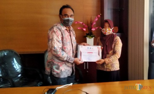 Rektor Unikama Dr Pieter Sahertian secara simbolis dalam penyerahan piagam penghargaan Muri. (Anggara Sudiongko/Malangtimes)