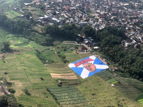 Bendera arema terbentang di Lapangan Songgomaruto, Kelurahan Songgomaruto, Kelurahan Songgokerto, Kecamatan Batu, Selasa (11/8/2020). (Foto: istimewa)