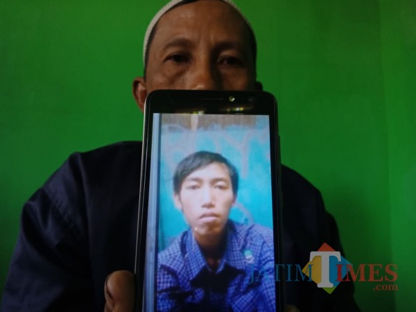 Gunain (50), menunjukkan foto keponakannya yang diyakini hilang diculik wewe gombel. (Foto : Adi Rosul / JombangTIMES)