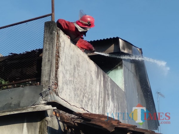 Petugas pemadam kebakaran saat berupaya memadamkan api di lantai 2 rumah korban (Foto : Istimewa)