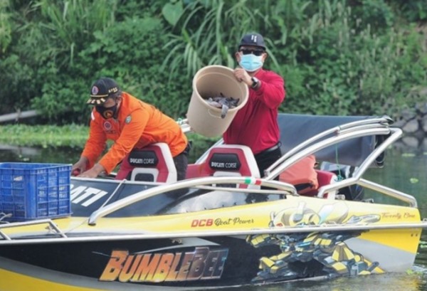 Wali kota Madiun Maidi saat menyebar 2 kwintal ikan lele.