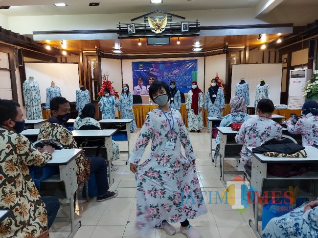 Salah satu pekerja pabrik rokok yang memperagakan gamis yang telah dibuat.